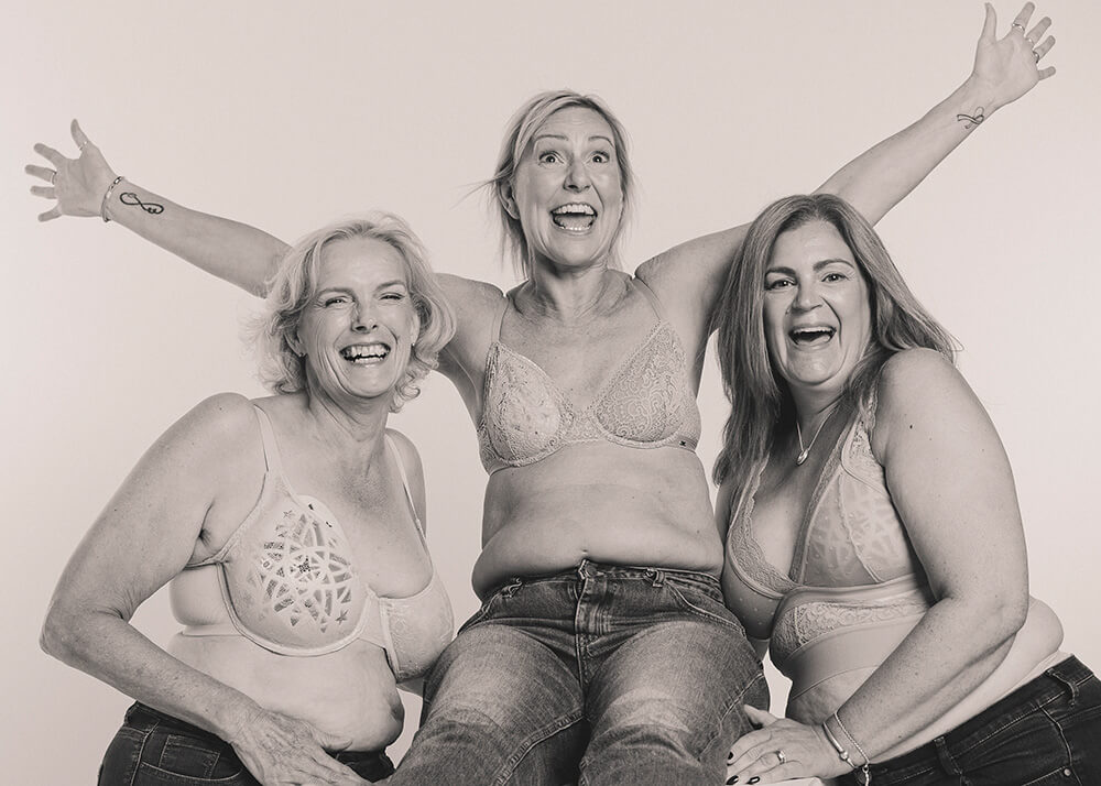 three mastecomty models wearing the boost breast form posing against a white backdrop